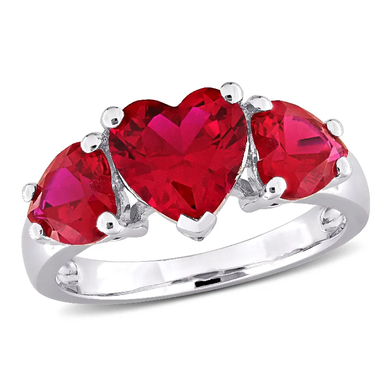 Gemstone rings featuring jade for green serene charm -Miadora 4 4/5ct TGW Created Ruby 3-Stone Heart Ring in Sterling Silver