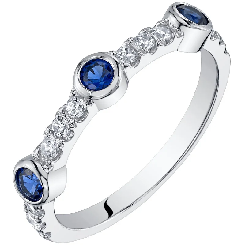 Gemstone rings featuring vivid stones for fierce flair -Sterling Silver Created Blue Sapphire Bezel Half Eternity Ring